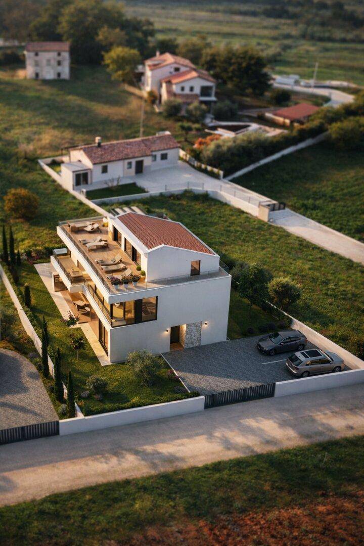 Vogelperspektive einer modernen Villa mit Flachdach, großzügiger Terrasse und umliegender Naturlandschaft.