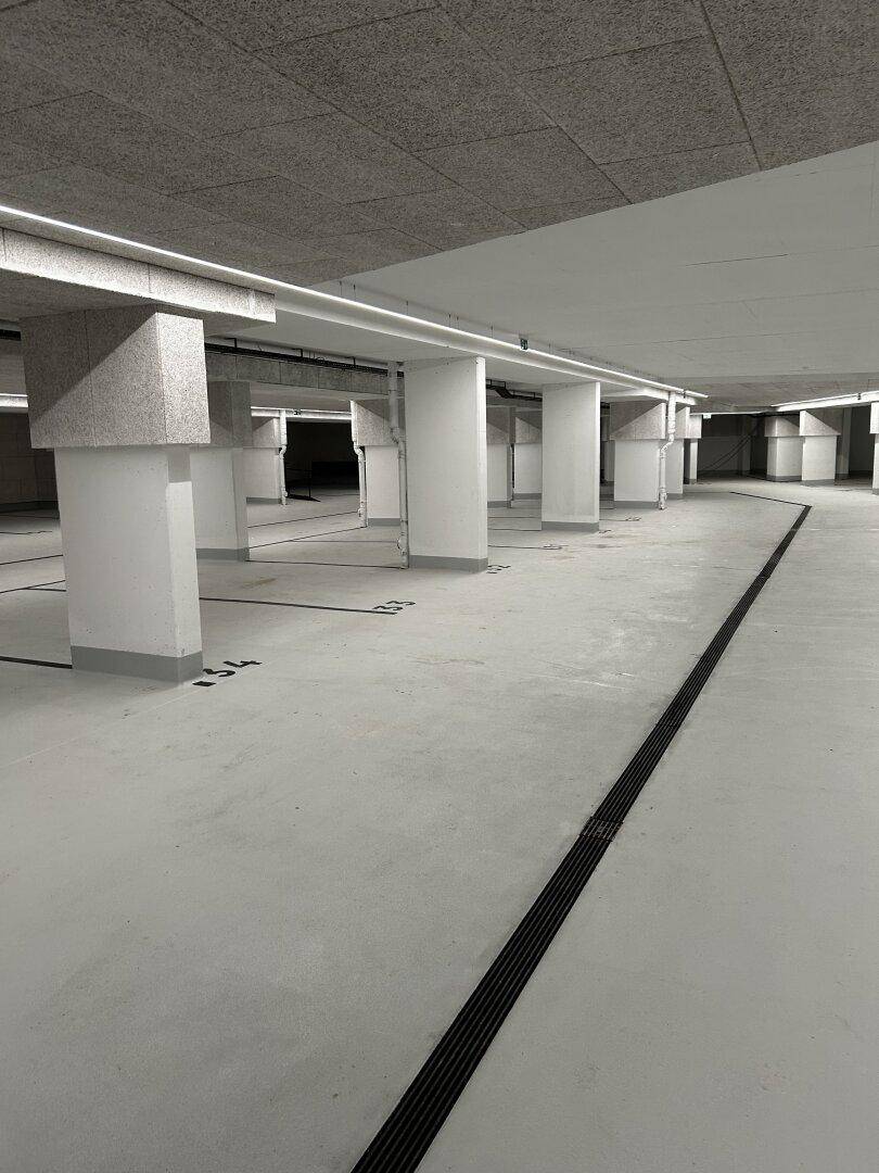 Geräumige Tiefgarage mit vielen Stellplätzen und guter Beleuchtung, bietet sicheres Parken.