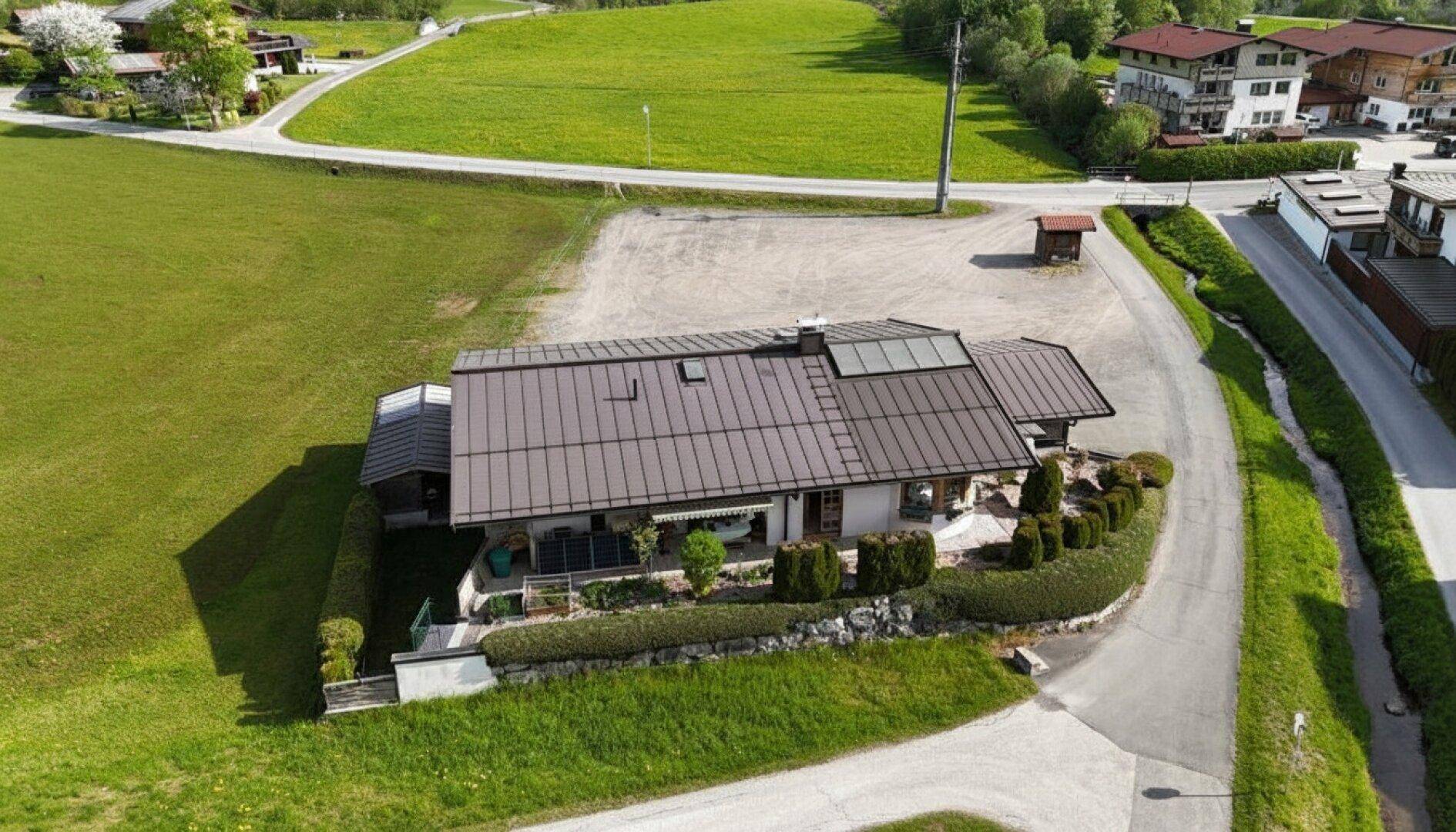 Weitläufige Luftaufnahme des Hauses in ländlicher Umgebung mit viel Grünfläche.