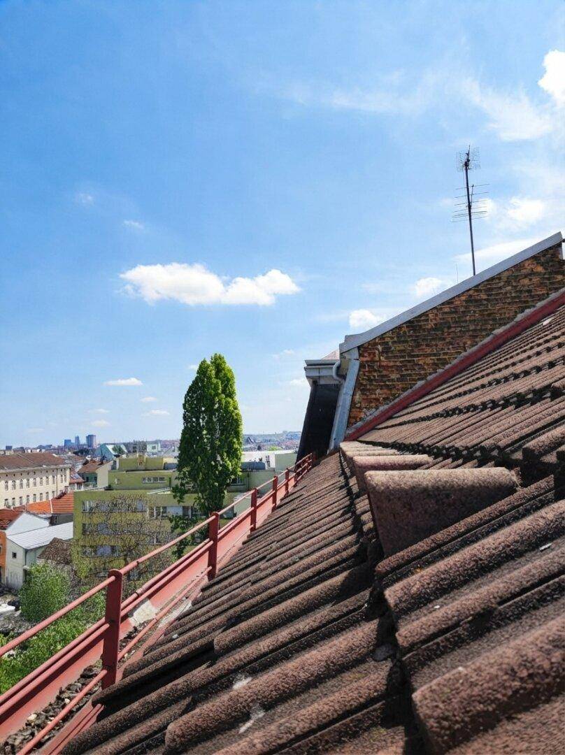 Panoramablick über die Dächer der Stadt mit weitem Horizont und blauem Himmel.