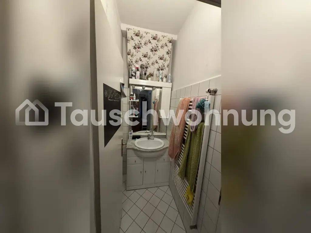 Kleines Badezimmer mit Waschbecken, Spiegel und weißen Fliesen an Wänden und Boden.