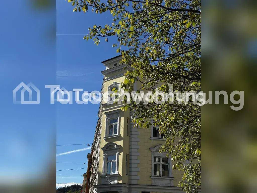 Historische Fassade eines Gebäudes mit gelbem Anstrich unter blauem Himmel.