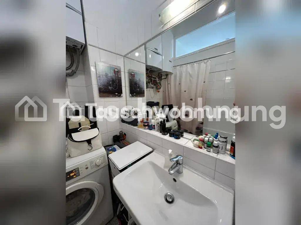 Badezimmer mit Waschbecken, Spiegel, Waschmaschine und Badewanne mit Duschvorhang.