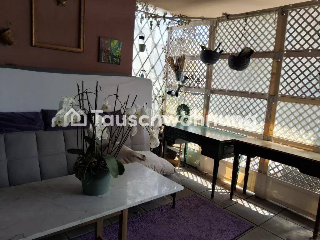 Heller Wintergarten mit bequemer Couch, Couchtisch und dekorativen Gitterfenstern, ideal zum Entspannen.