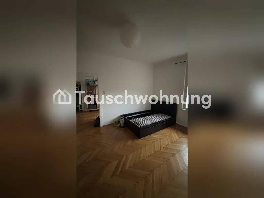 Zimmer mit Parkettboden und Bettgestell, das zu einem weiteren Raum führt.