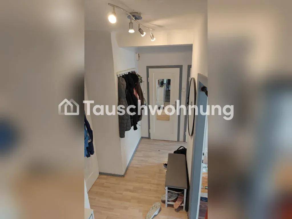 Heller Flur mit Garderobe, Spiegel und Sitzbank, ausgestattet mit hellem Laminatboden.
