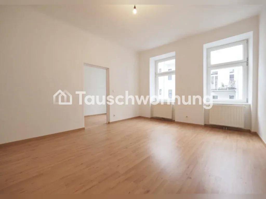 Geräumiges, helles Zimmer mit Parkettboden und großen Fenstern, ideal für Wohnzwecke.