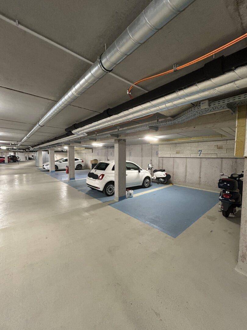 Geräumige Tiefgarage mit mehreren Stellplätzen und guter Beleuchtung, gut zugänglich.