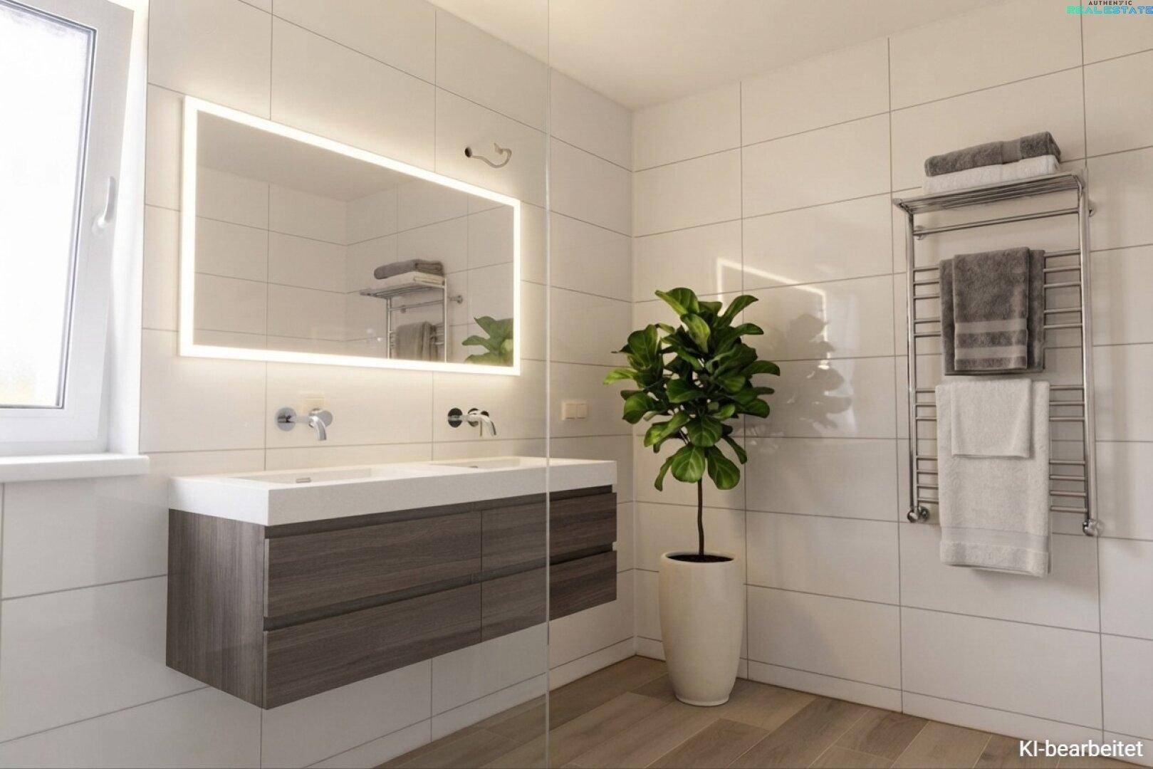 Modernes Badezimmer mit Doppelwaschbecken, beleuchtetem Spiegel und Handtuchheizkörper.