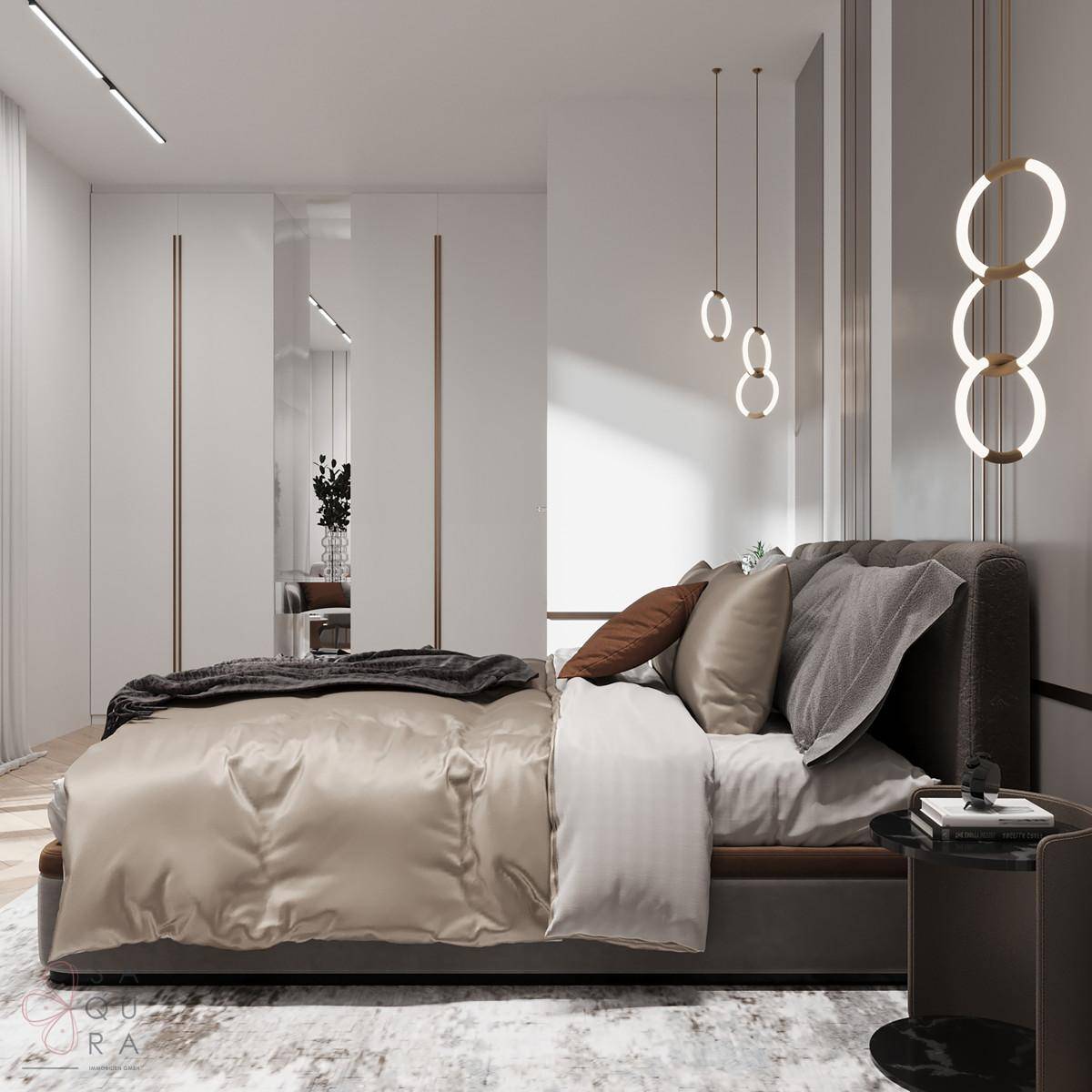 Modernes Schlafzimmer mit großem Bett, eleganten Pendelleuchten und integrierten Kleiderschränken.