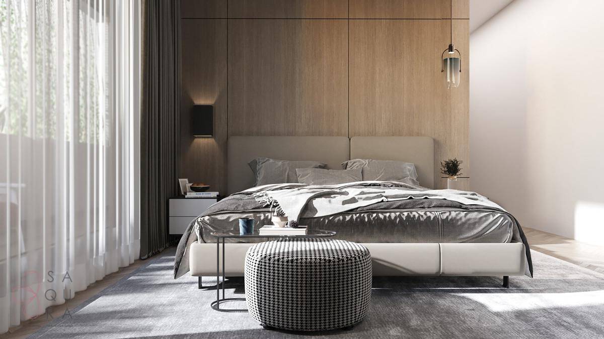 Helles Schlafzimmer mit Holzwand, bequemen Bett und stilvoller Einrichtung.