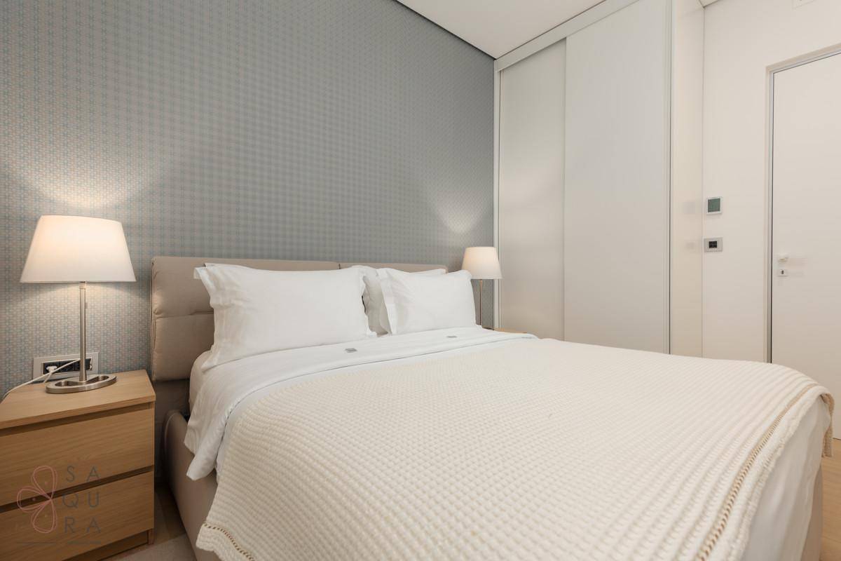 Ein modernes Schlafzimmer mit Doppelbett, integrierten Schränken und einer stilvollen Wandgestaltung.