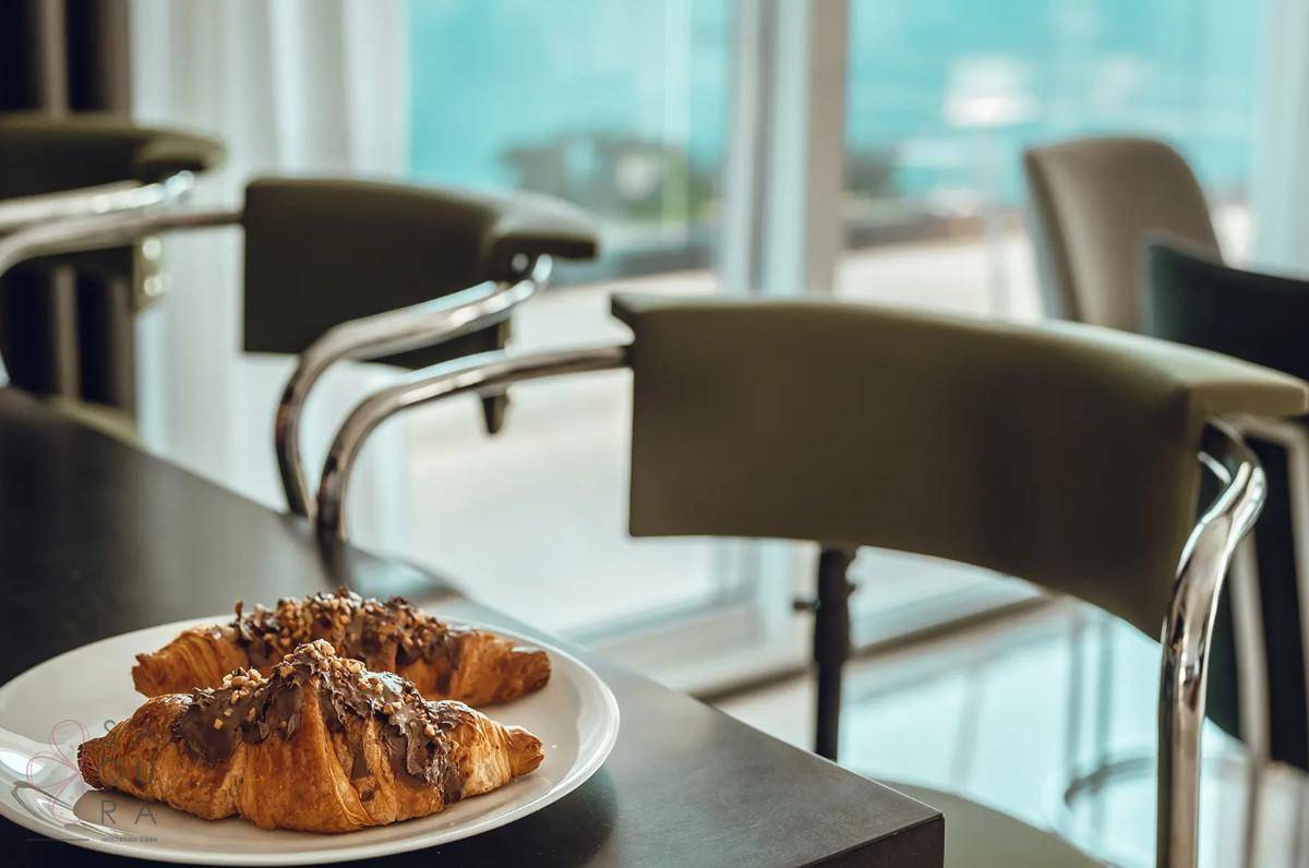 Nahaufnahme von Croissants auf der Frühstücksbar mit Blick auf das Meer im Hintergrund.