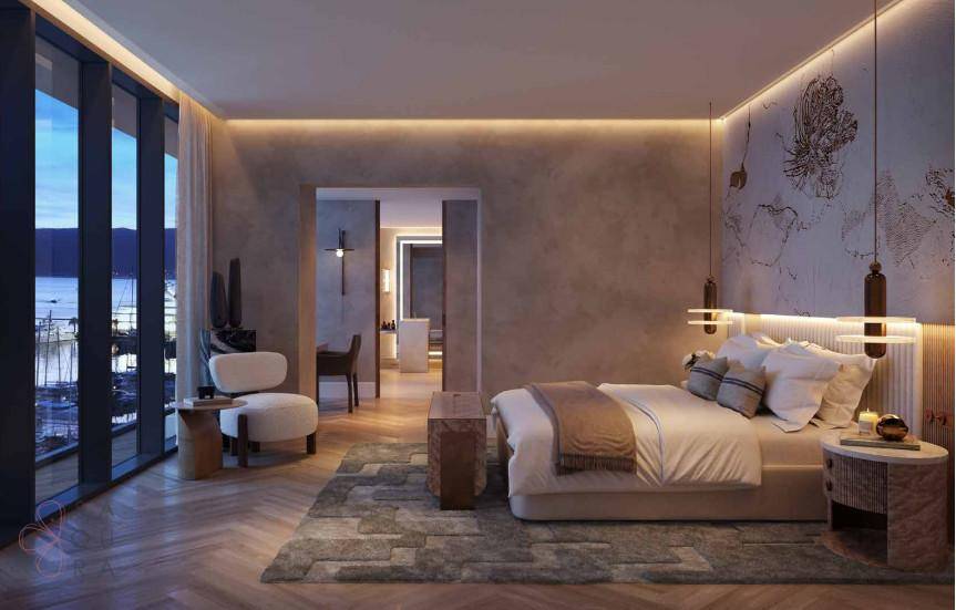 Geräumiges Schlafzimmer mit großen Fenstern, Meerblick und direktem Zugang zu einem luxuriösen Badezimmer.