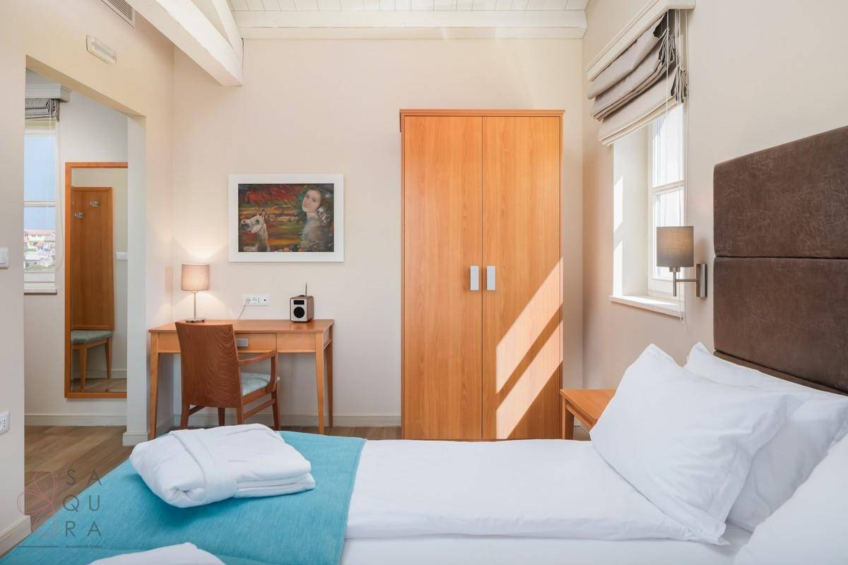 Komfortables Schlafzimmer mit Doppelbett, Schreibtisch und großem Kleiderschrank, hell und einladend.