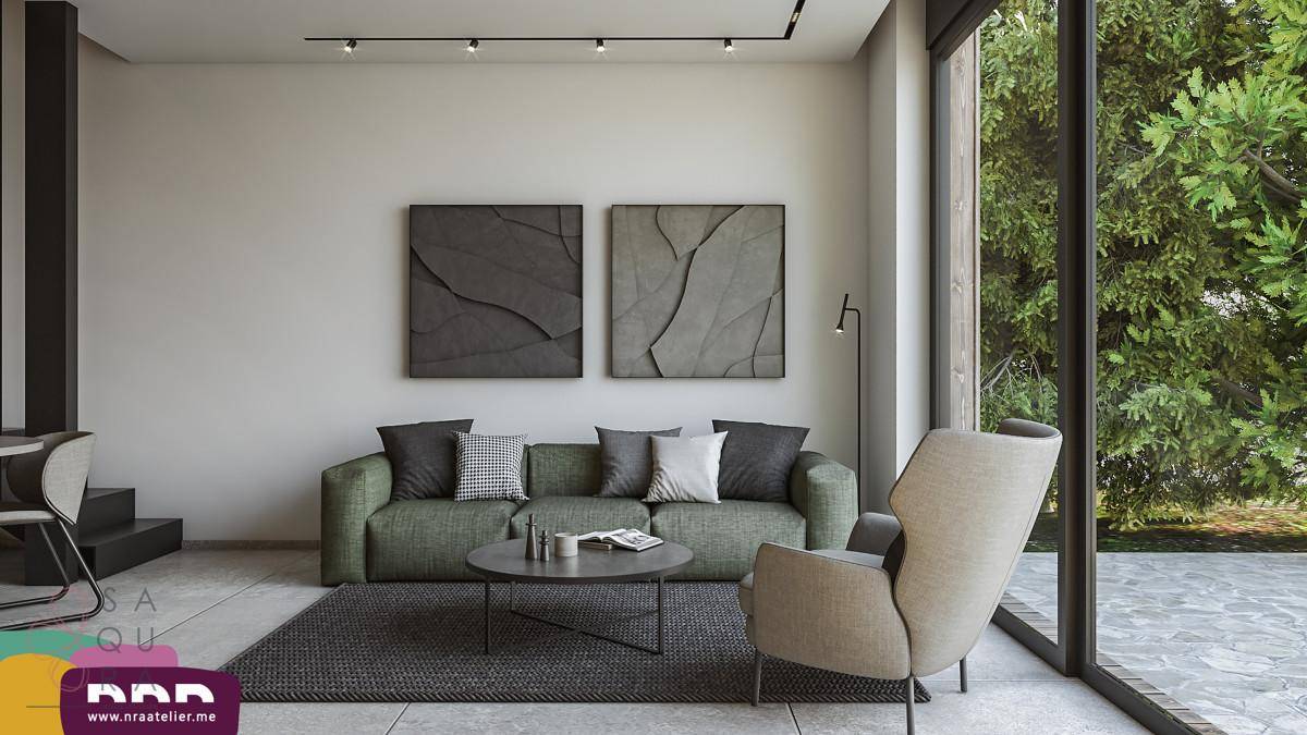 Modernes Wohnzimmer mit bequemer Couch, großem Fenster und Blick ins Grüne.