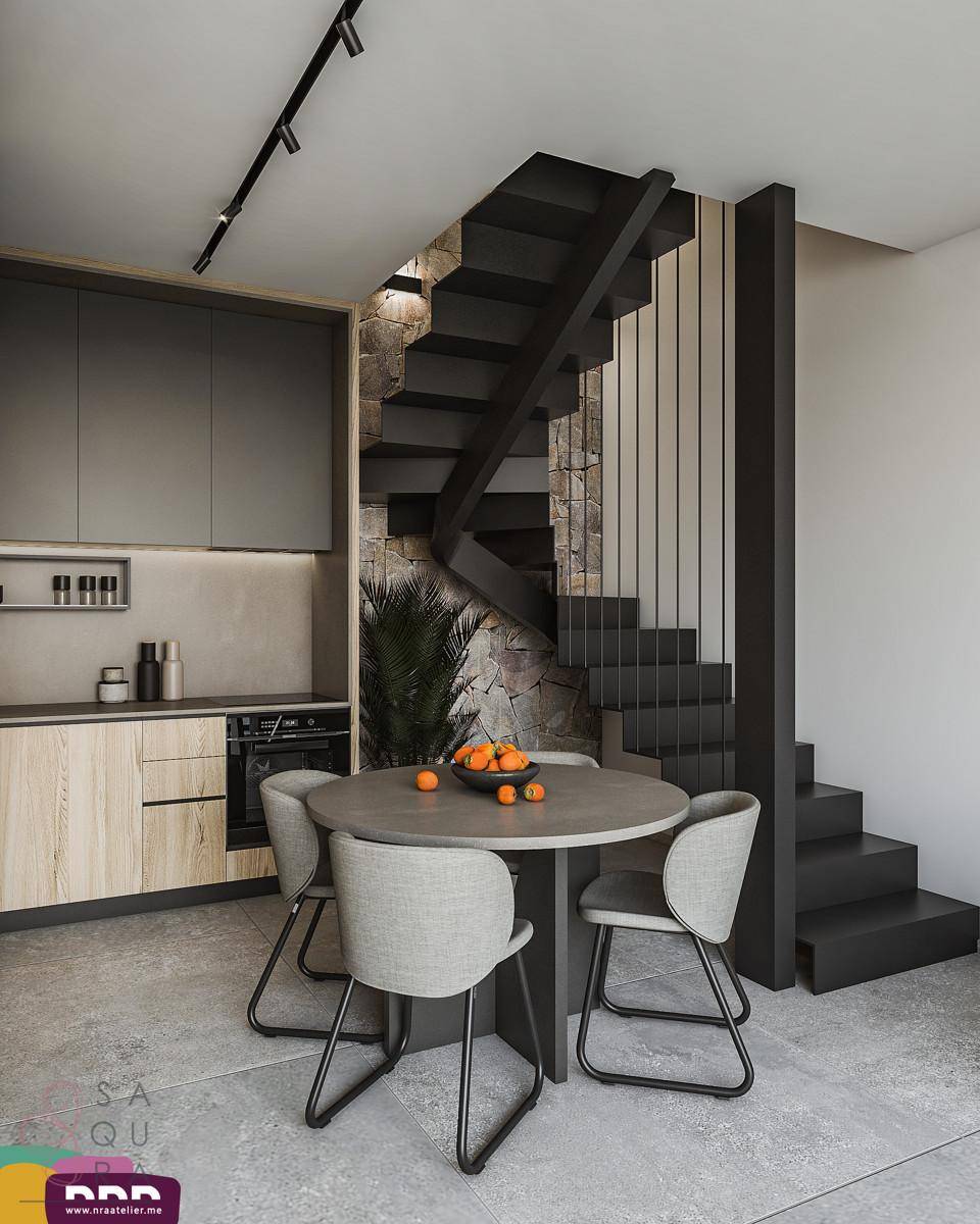 Kompakte Küche mit Essbereich und einer eleganten schwarzen Treppe mit Steinwandakzent.