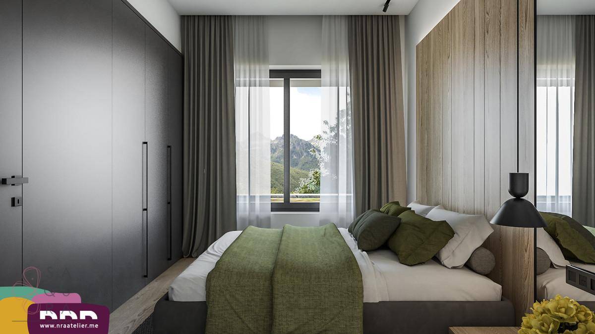 Schlafzimmer mit dunklen Einbauschränken und Fenster, das einen weiten Blick auf die Berge bietet.