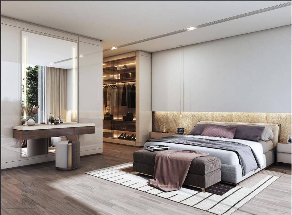 Modernes Schlafzimmer mit integriertem Ankleidebereich, Schminktisch und Holzboden.