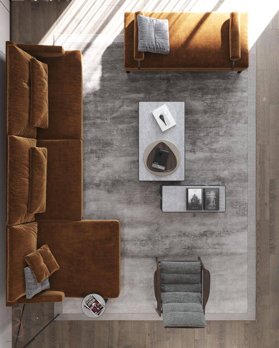 Draufsicht auf ein elegantes Wohnzimmer mit L-förmigem Sofa, Sessel und zwei Couchtischen auf einem Teppich.