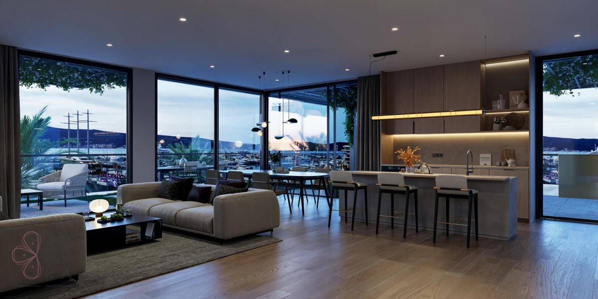Stimmungsvoller offener Wohnbereich bei Nacht mit beleuchteter Küche und Meerblick.