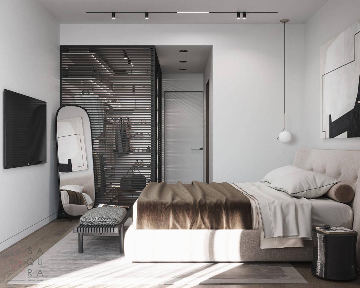 Helles Schlafzimmer mit modernem Bett, Fernseher und einem eleganten Raumteiler zum Ankleidebereich.