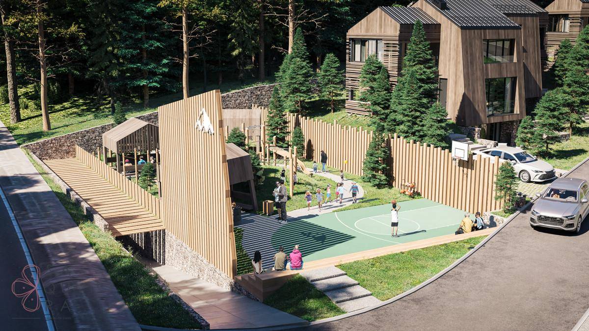 Außenbereich der Wohnanlage mit Basketballplatz, Spielplatz und viel Grün.