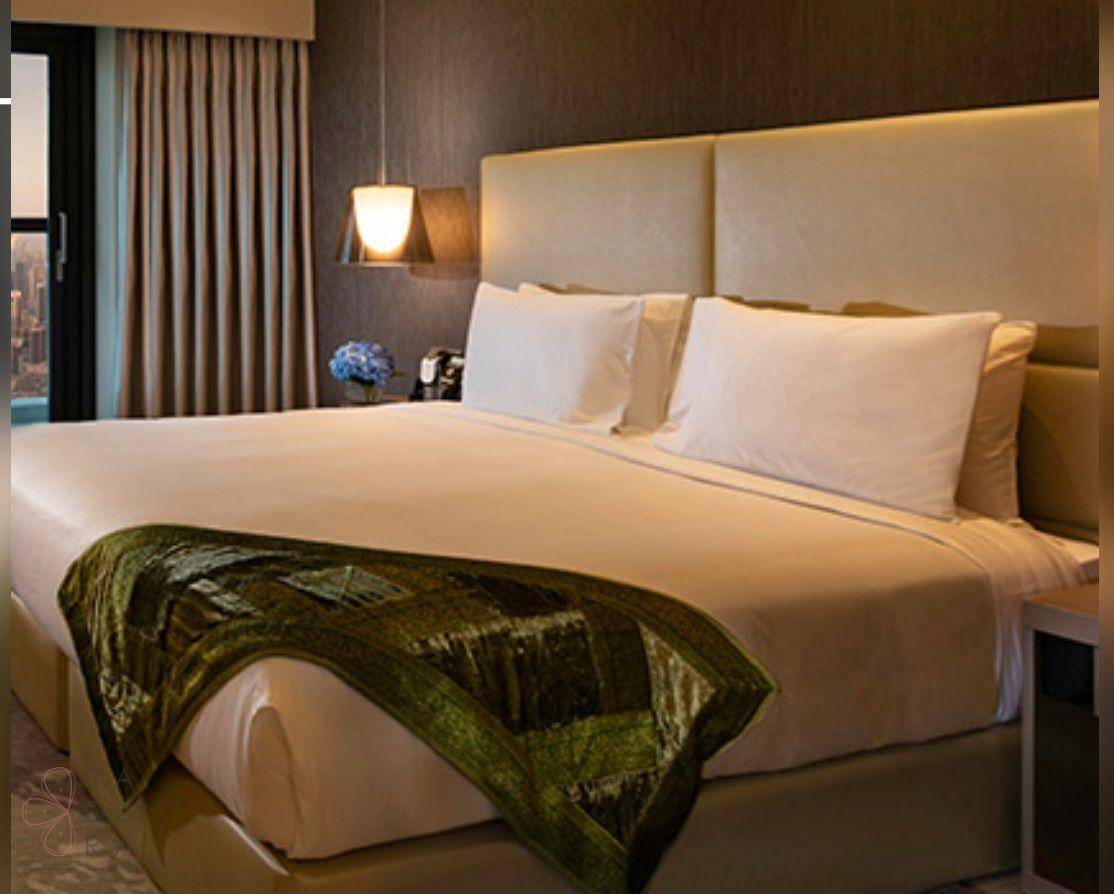 Komfortables Schlafzimmer mit großem Bett, gepolstertem Kopfteil und stilvoller Decke.