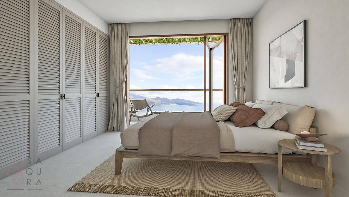 Schlafzimmer mit Meerblick, großen Fenstern und integrierten Schränken für optimalen Stauraum.