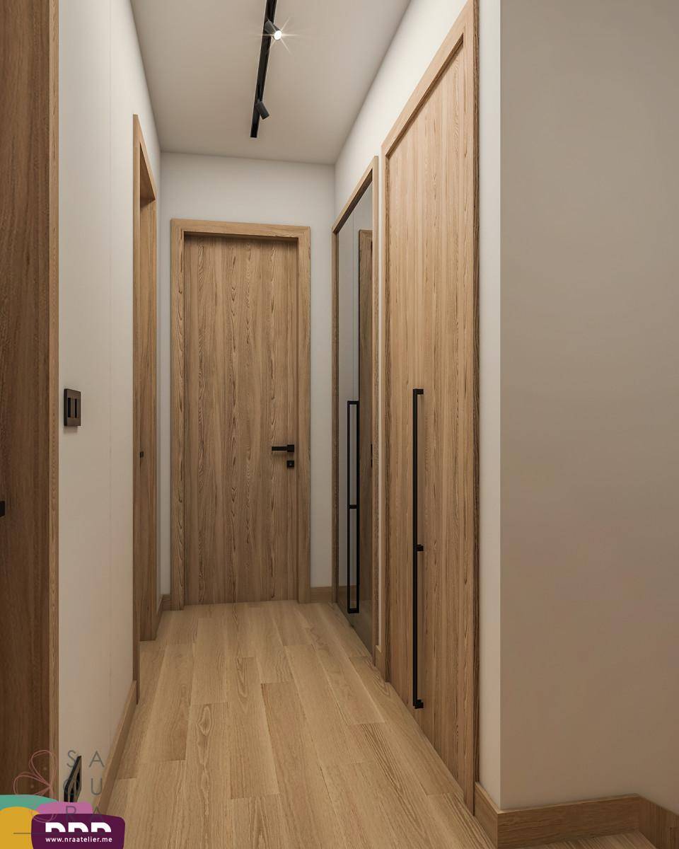 Heller Flur mit Holzboden, Holztüren und integrierten Schränken.