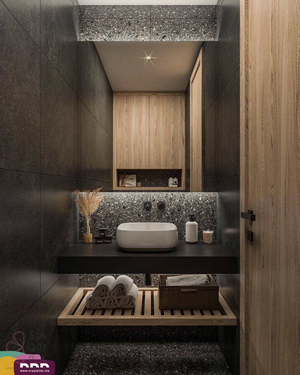 Modernes WC mit dunklen Fliesen, elegantem Waschbecken und Holzdetails.