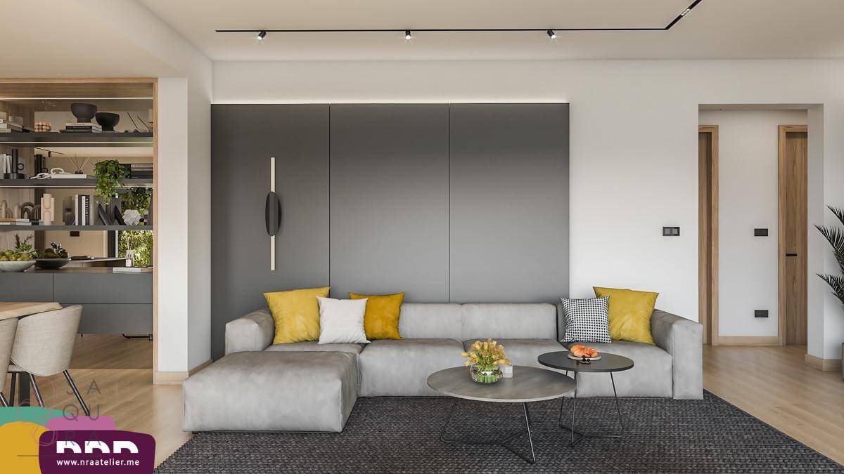 Modernes Wohnzimmer mit bequemer Couch, stilvoller Wandgestaltung und minimalistischer Dekoration.