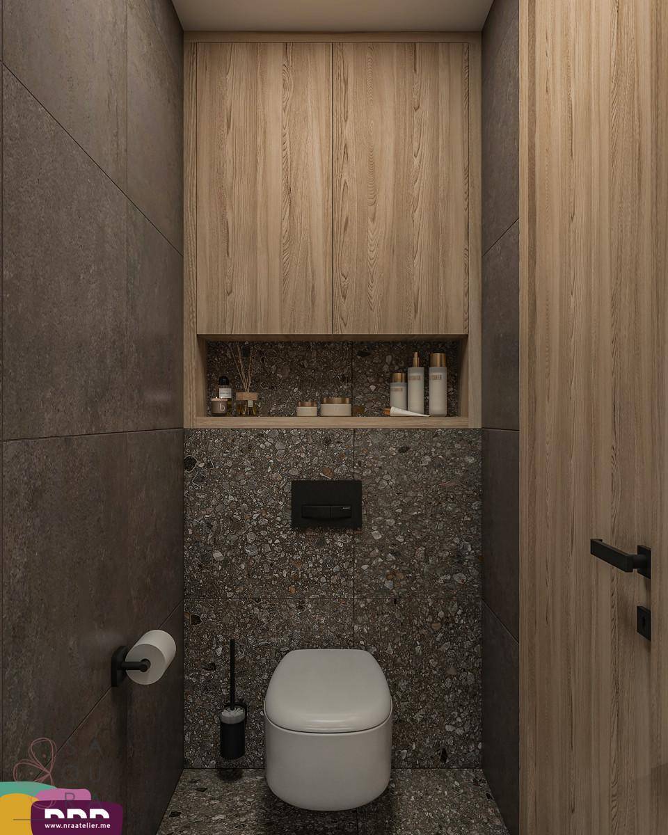 Kompaktes Gäste-WC mit dunklen Fliesen, Wand-WC und Holzschrank über der Toilette.