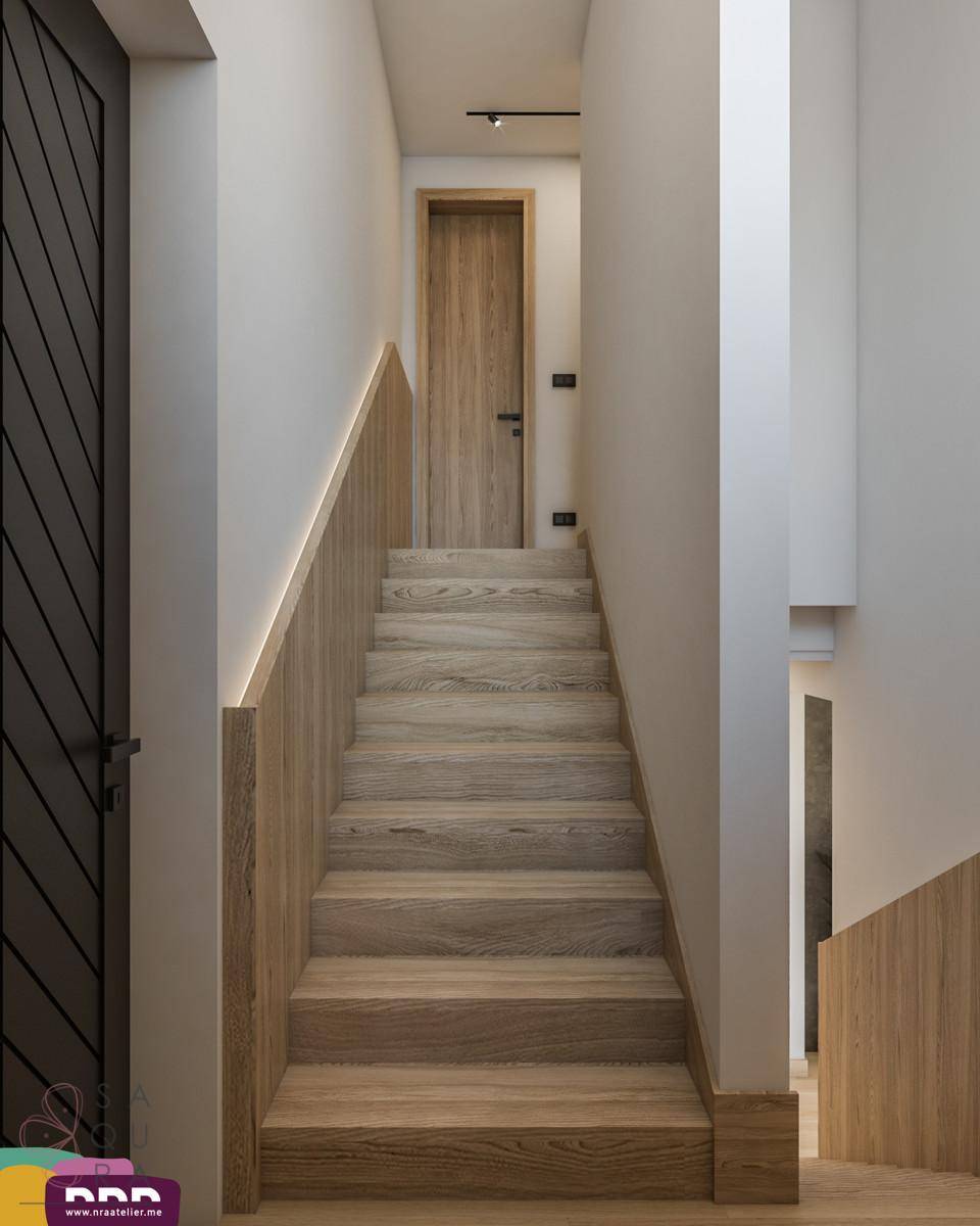Holztreppe mit modernem Geländer, die in die obere Etage führt.
