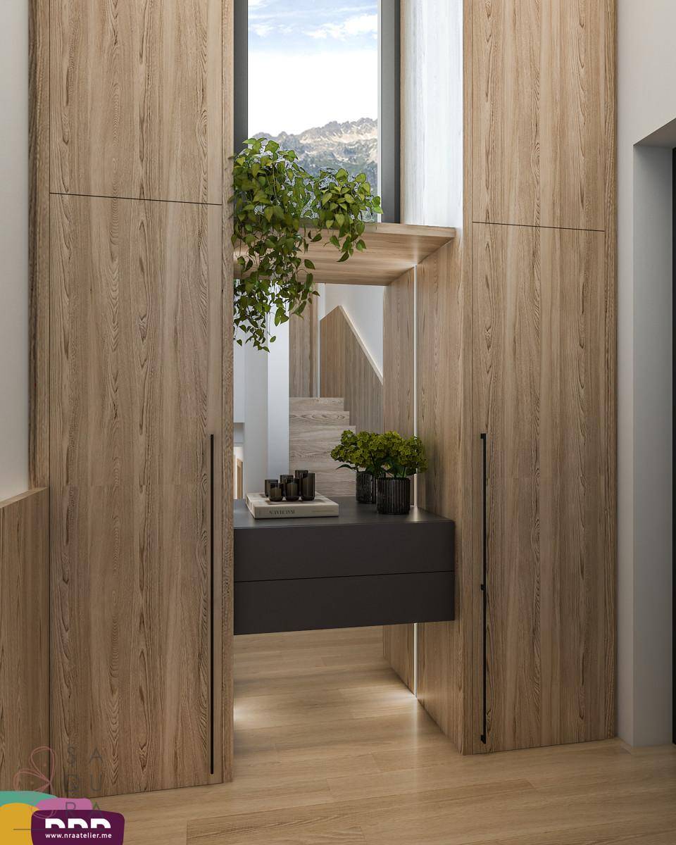 Eingangsbereich mit Holzeinbauschränken, Ablagefläche und Blick auf eine Treppe.
