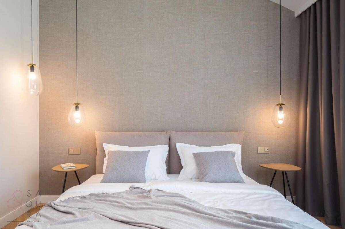 Gemütliches Schlafzimmer mit Doppelbett, Nachttischen und stilvollen Hängelampen.