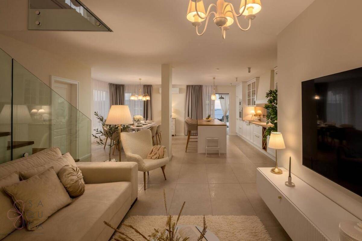 Offener Wohn- und Essbereich mit integrierter Küche, modernem Design und viel natürlichem Licht.