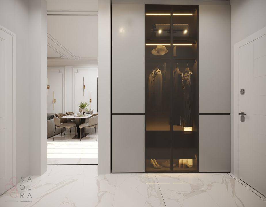 Heller Eingangsbereich mit Marmorboden und einem eleganten, beleuchteten Einbauschrank, der viel Stauraum bietet.