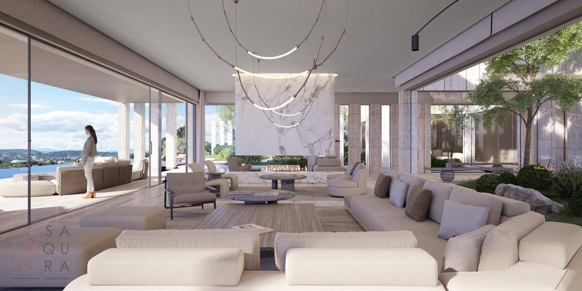 Geräumiges Wohnzimmer mit eleganten Möbeln, Kamin und großen Schiebetüren zur Terrasse.