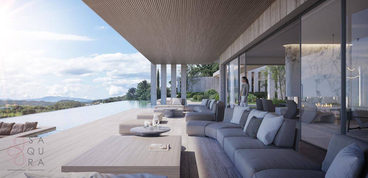 Luxuriöse Terrasse mit bequemen Lounge-Möbeln, Infinity-Pool und weitem Panoramablick.