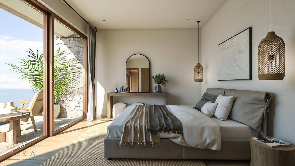 Helles Schlafzimmer mit Holzboden, Meerblick und Zugang zu einer privaten Terrasse.