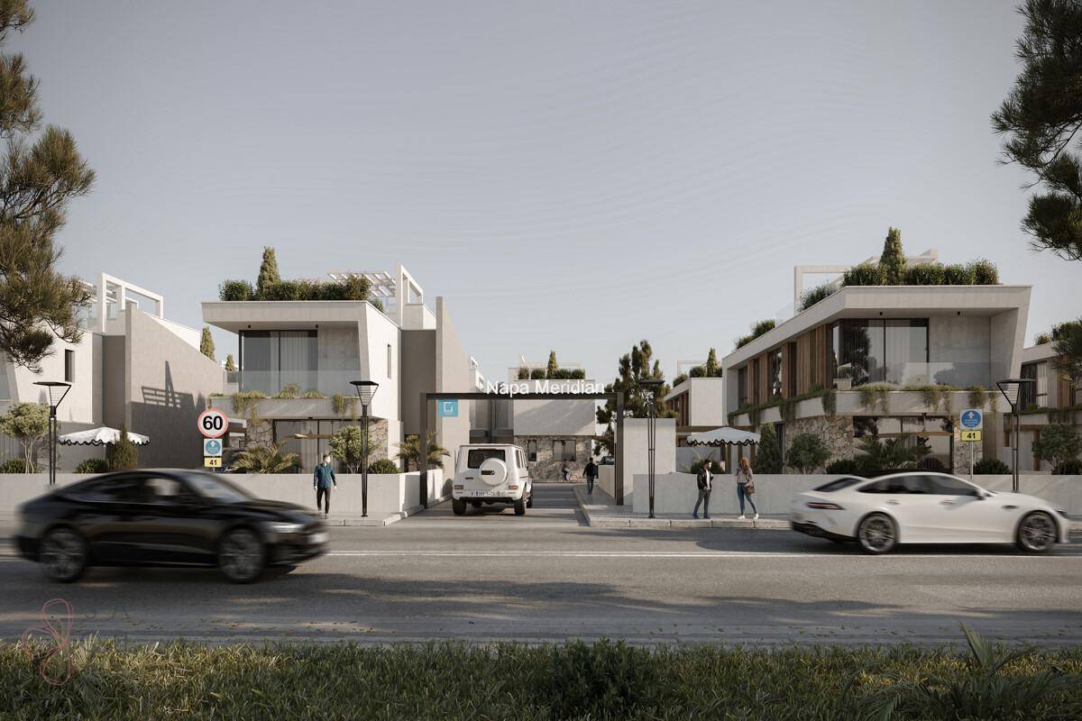 Weitläufige Ansicht einer modernen Wohnanlage mit Villen, begrünten Dächern und breiter Zufahrtsstraße.