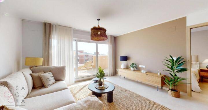 Heller Wohnbereich mit beigem Sofa, Holzelementen und Zugang zum Balkon, sehr einladend.