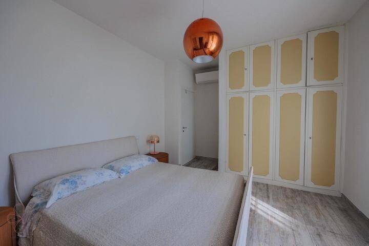 Schlafzimmer mit Doppelbett und praktischen Einbauschränken für ausreichend Stauraum.