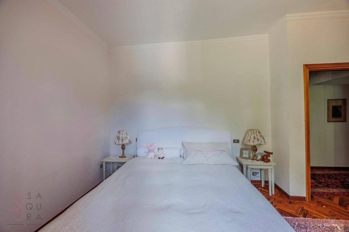 Schlafzimmer mit Doppelbett, zwei Nachttischen und schlichter, heller Einrichtung.