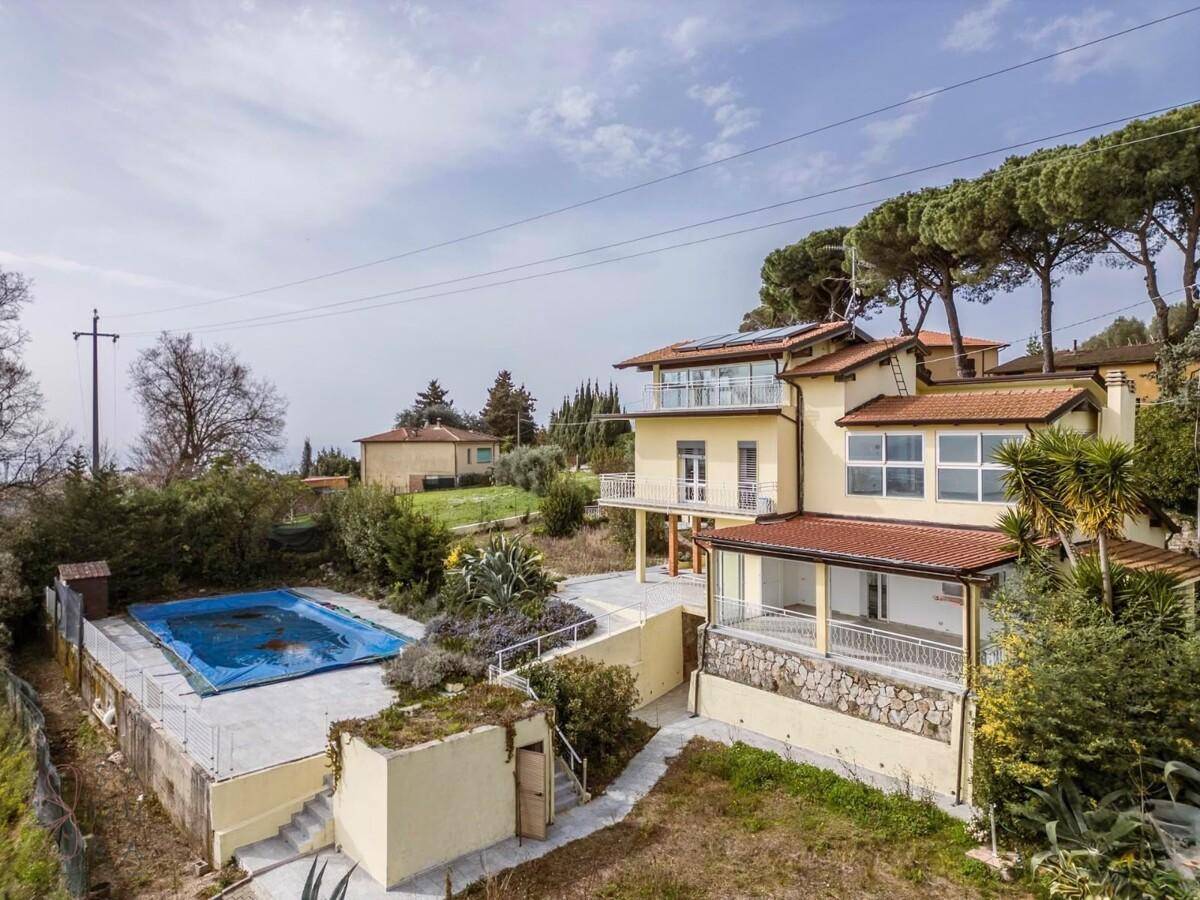 Luftaufnahme der gelben Villa mit Poolbereich und Panoramablick über die umliegende Landschaft.