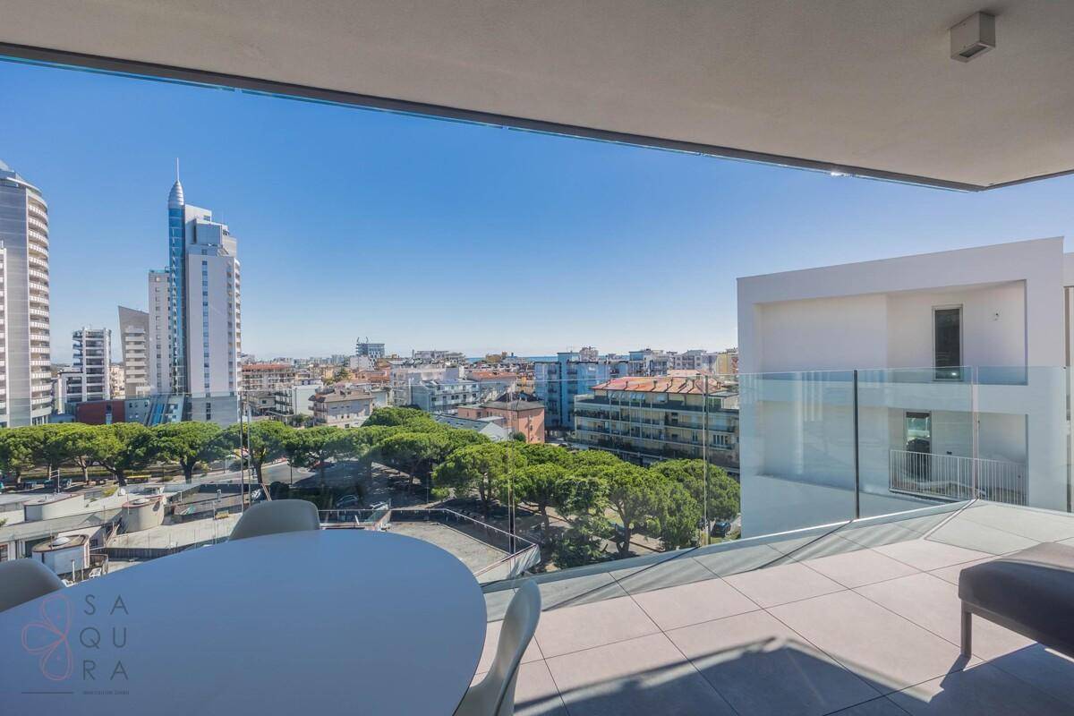 Großer Balkon mit Esstisch und weitem Blick auf die Stadt und die umliegende Landschaft.
