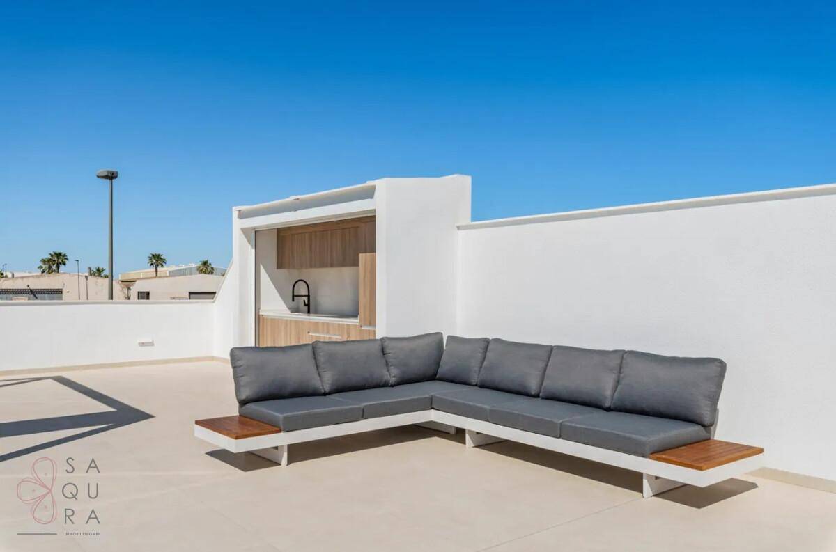 Dachterrasse mit moderner Lounge-Sitzgruppe und integrierter Außenküche für gesellige Abende.