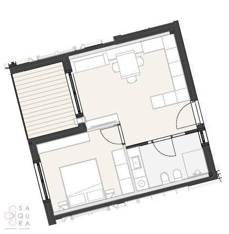 Grundriss einer Wohnung mit offenem Wohnbereich, Schlafzimmer, Bad und Balkon.