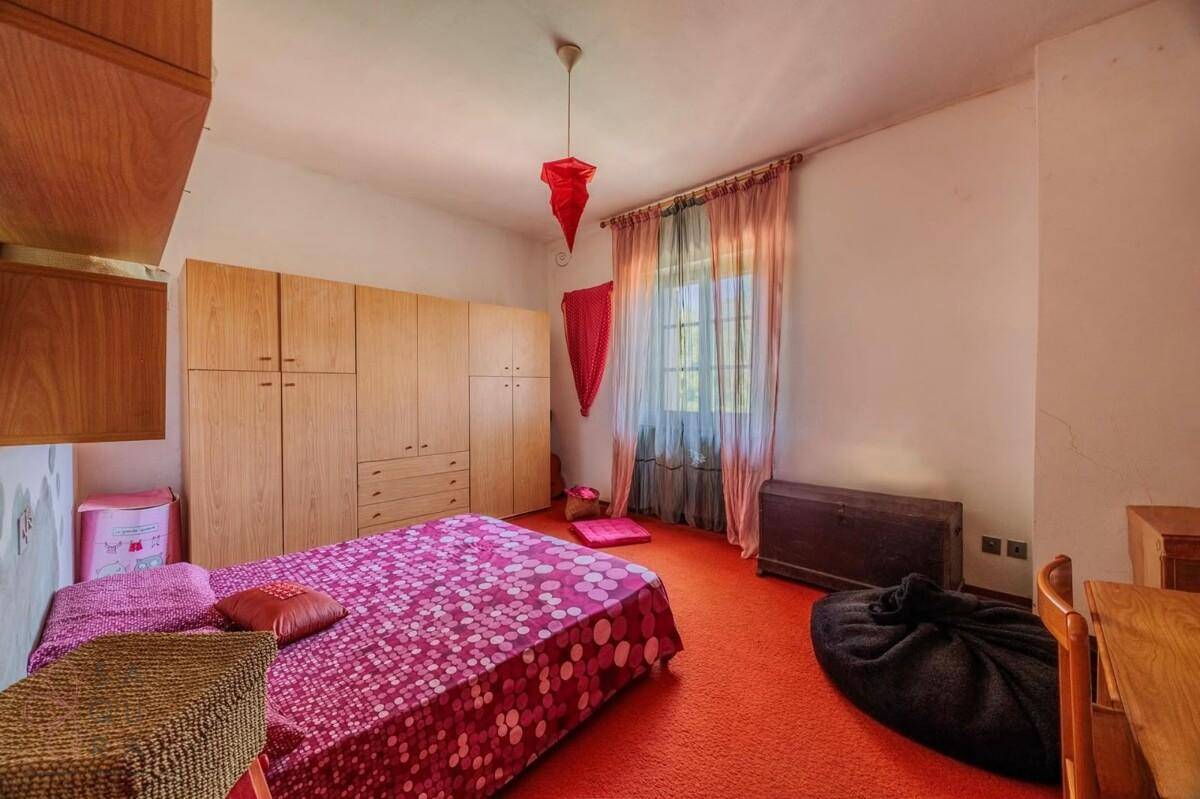 Farbiges Schlafzimmer mit rotem Teppichboden und Holzschränken, bietet eine gemütliche Atmosphäre.